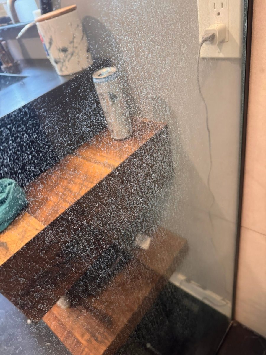 Glass shower door before Tidy Sparkles cleaning