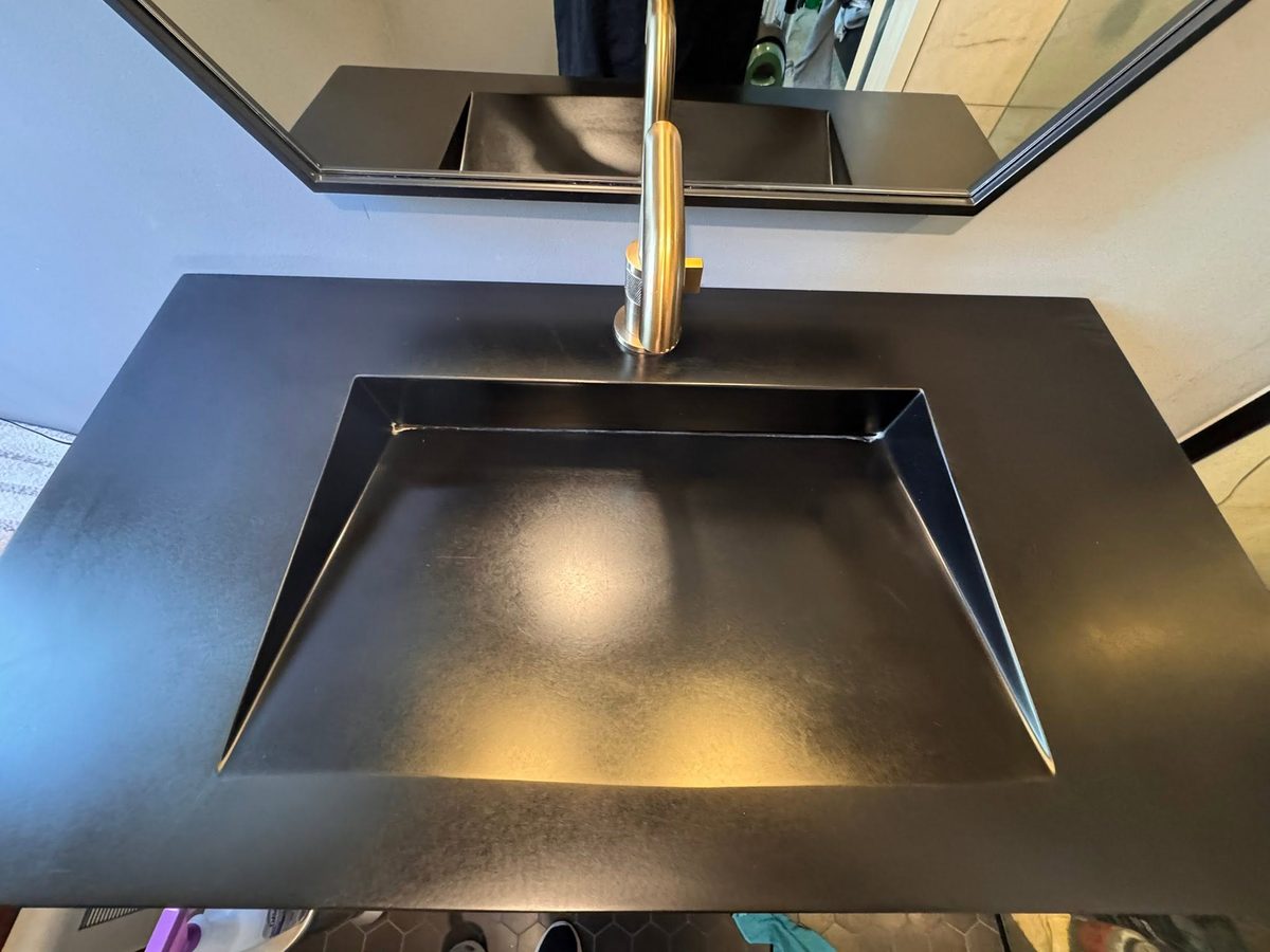 Black trough sink after Tidy Sparkles cleaning